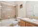 Well-lit bathroom with a tiled shower and tub combination, neutral colors, and a modern vanity at 10559 Coral Key Ave, Tampa, FL 33647