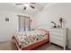Comfortable bedroom with a vaulted ceiling, a cozy bed, and a quaint decorative window at 10559 Coral Key Ave, Tampa, FL 33647