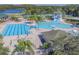 Expansive community pool area with water slide, tennis courts, and plenty of seating for residents to enjoy the Florida sunshine at 10559 Coral Key Ave, Tampa, FL 33647