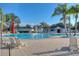Inviting community pool surrounded by lounge chairs, umbrellas, and lush landscaping, perfect for relaxation and recreation at 10559 Coral Key Ave, Tampa, FL 33647