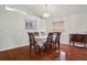 Bright dining room with hardwood floors, neutral paint, chandelier, and large windows at 10559 Coral Key Ave, Tampa, FL 33647