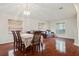 Bright dining and living room with hardwood floors, chandelier, and large windows at 10559 Coral Key Ave, Tampa, FL 33647