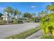 The community entrance features a gate, palm trees, and well-kept landscaping, creating a serene and inviting atmosphere at 10559 Coral Key Ave, Tampa, FL 33647