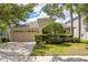 Charming single-Gathering home with mature landscaping, a two-car garage, and well-manicured lawn at 10559 Coral Key Ave, Tampa, FL 33647