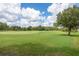 Picturesque golf course with lush green grass and trees, perfect for recreation at 10559 Coral Key Ave, Tampa, FL 33647