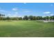Expansive golf course view with blue skies, meticulously maintained greens and sand traps surrounded by lush trees and tropical vegetation at 10559 Coral Key Ave, Tampa, FL 33647