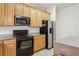 Kitchen area with wood cabinets, granite countertops, stainless appliances, and overhead microwave at 10559 Coral Key Ave, Tampa, FL 33647