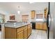 Kitchen with wood cabinets, granite countertops, bar seating, and stainless appliances at 10559 Coral Key Ave, Tampa, FL 33647