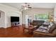 Spacious living room with hardwood floors, comfortable seating, and easy access to the outdoor patio at 10559 Coral Key Ave, Tampa, FL 33647