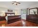 Main bedroom with hardwood floors, a large bed, and a full set of matching bedroom furniture at 10559 Coral Key Ave, Tampa, FL 33647