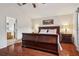 Main bedroom showcasing hardwood floors, a king-sized bed, and an en-suite bathroom entrance at 10559 Coral Key Ave, Tampa, FL 33647