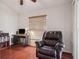 Cozy office space with hardwood floors, a functional desk setup, and a comfortable chair at 10559 Coral Key Ave, Tampa, FL 33647