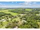 A neighborhood aerial showing mature trees and large grassy areas at 11317 Fort King Rd, Dade City, FL 33525