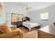 Bedroom featuring a bed, chair, ceiling fan and laminate wood flooring at 11317 Fort King Rd, Dade City, FL 33525