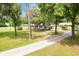 The home features mature trees, landscaping and a long, paved driveway at 11317 Fort King Rd, Dade City, FL 33525
