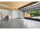 Spacious garage with epoxy flooring, washer/dryer and an open garage door providing a bright, open space at 11317 Fort King Rd, Dade City, FL 33525