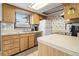Cozy kitchen with light wood cabinets, white appliances, and a window above the sink providing natural light at 11317 Fort King Rd, Dade City, FL 33525