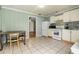 Kitchen with tile flooring, light green walls, and white appliances and cabinets at 11317 Fort King Rd, Dade City, FL 33525