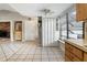 Spacious kitchen featuring tile flooring, a folding door, and views into other areas of the home at 11317 Fort King Rd, Dade City, FL 33525