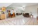 Spacious living room with tile flooring, vaulted ceilings, dining area and comfortable furnishings at 11317 Fort King Rd, Dade City, FL 33525