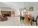 Open-concept living room showcasing tile flooring, dining area, kitchen, and brick fireplace at 11317 Fort King Rd, Dade City, FL 33525