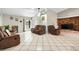 Cozy living room featuring tile floors, vaulted ceiling, brick fireplace, and comfortable seating at 11317 Fort King Rd, Dade City, FL 33525