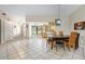 Open-concept living room showcasing tile flooring, dining area, kitchen, and multiple entry points at 11317 Fort King Rd, Dade City, FL 33525