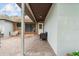 Covered brick patio featuring a seating area, white door and exterior paint at 11317 Fort King Rd, Dade City, FL 33525