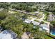 Scenic aerial view of a neighborhood showcases single-Gathering homes, tree coverage, and street layout at 1144 Woodbrook Dr, Largo, FL 33770
