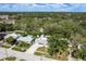 Wide aerial view of the neighborhood showcasing single-story homes among mature trees at 1144 Woodbrook Dr, Largo, FL 33770