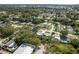 High angle aerial of a suburban neighborhood with lush greenery and an array of single-Gathering homes at 1144 Woodbrook Dr, Largo, FL 33770