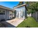 View of a metal shed with a wooden deck and artificial grass in the backyard of this charming home at 1144 Woodbrook Dr, Largo, FL 33770