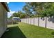The backyard features artificial grass, shed, and privacy fence providing a serene outdoor space at 1144 Woodbrook Dr, Largo, FL 33770
