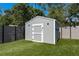 Backyard featuring a shed and artificial grass providing a low-maintenance and aesthetically pleasing outdoor space at 1144 Woodbrook Dr, Largo, FL 33770