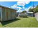 Backyard view showcases an above-ground pool, a shed, and a fenced yard creating a private oasis at 1144 Woodbrook Dr, Largo, FL 33770