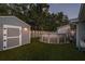 Backyard features a pool, a storage shed, and artificial turf for easy maintenance at 1144 Woodbrook Dr, Largo, FL 33770