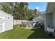 Backyard featuring an above-ground pool and two sheds at 1144 Woodbrook Dr, Largo, FL 33770