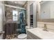 Bathroom with glass enclosed shower, vanity with sink, and wood-look tile and walls at 1144 Woodbrook Dr, Largo, FL 33770