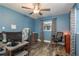 Bright bedroom with wood-look flooring, ceiling fan, and desk at 1144 Woodbrook Dr, Largo, FL 33770