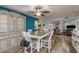 The dining room features a stylish table set, elegant hutch, and modern lighting with hardwood style flooring at 1144 Woodbrook Dr, Largo, FL 33770