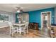 Inviting dining area with a rustic table set, decorative cabinet, and a view to the bathroom and living room area at 1144 Woodbrook Dr, Largo, FL 33770