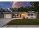 Charming single-story home with a well-manicured lawn, paved driveway, and cozy front porch at 1144 Woodbrook Dr, Largo, FL 33770