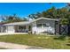 Beautiful single-story home featuring a well-kept lawn and a charming curb appeal with lush landscaping at 1144 Woodbrook Dr, Largo, FL 33770