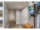 Cozy hallway with wood-look flooring, neutral walls, and a charming collection of baseball caps on a stand at 1144 Woodbrook Dr, Largo, FL 33770