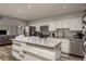 Modern kitchen with granite countertops, white cabinets, stainless appliances, and a center island at 1144 Woodbrook Dr, Largo, FL 33770