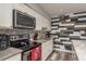 Updated kitchen featuring stainless steel appliances, granite countertops, and stylish backsplash at 1144 Woodbrook Dr, Largo, FL 33770