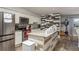 Bright kitchen with white cabinets, stainless steel appliances, and a unique backsplash design at 1144 Woodbrook Dr, Largo, FL 33770