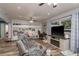 Open living area with stylish built-in shelving, modern tv console with fireplace, and wood-look flooring at 1144 Woodbrook Dr, Largo, FL 33770