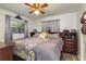 Bedroom with ceiling fan, natural light from windows, and decoratively arranged furniture at 1144 Woodbrook Dr, Largo, FL 33770