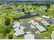 Aerial view of neighborhood featuring lush golf course, serene ponds, and mature trees at 1210 Eastloch Ct, Sun City Center, FL 33573